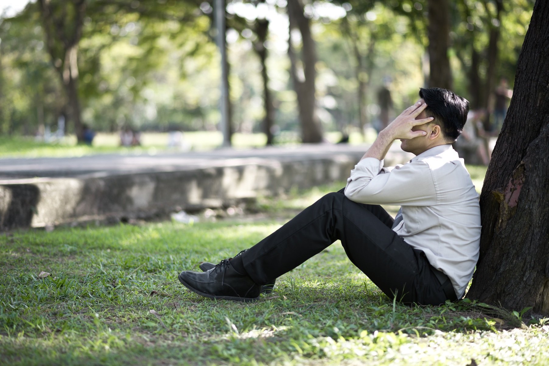 business-man-failing-and-serious-under-tree-in-the-2026-03-26-06-27-08-utc