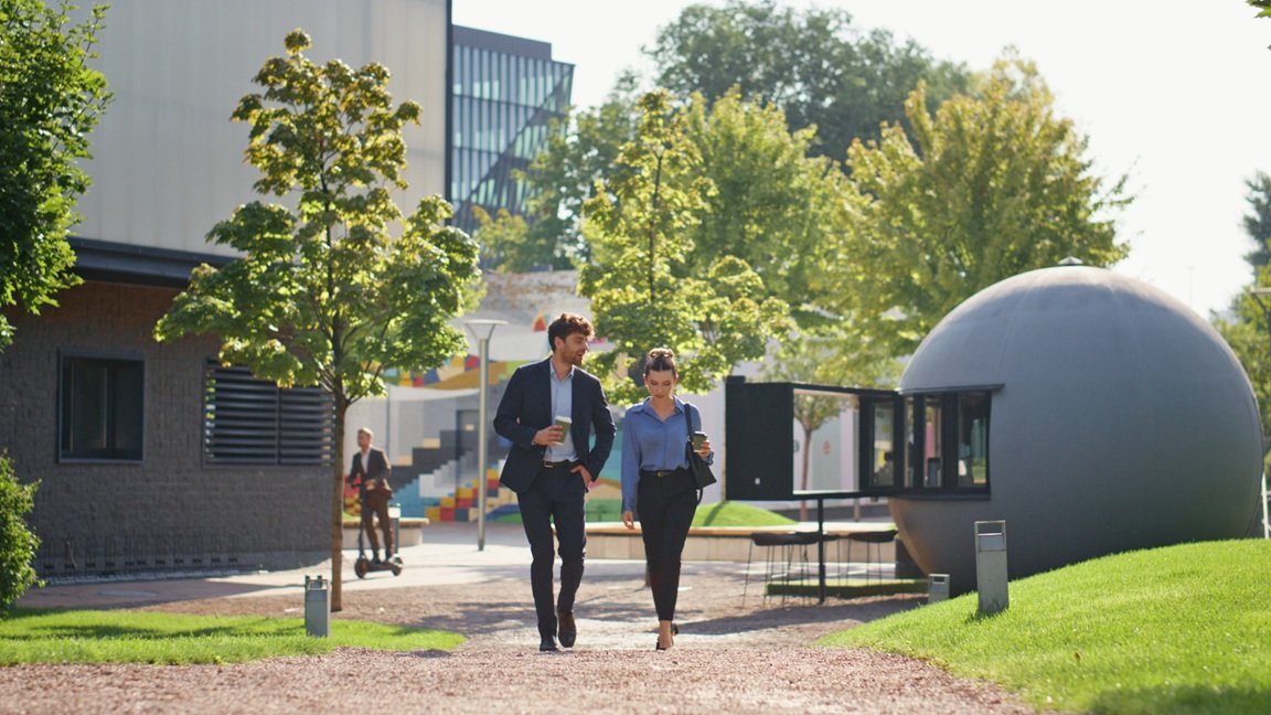 business-professionals-walking-and-talking-outdoor-2026-03-11-01-01-12-utc
