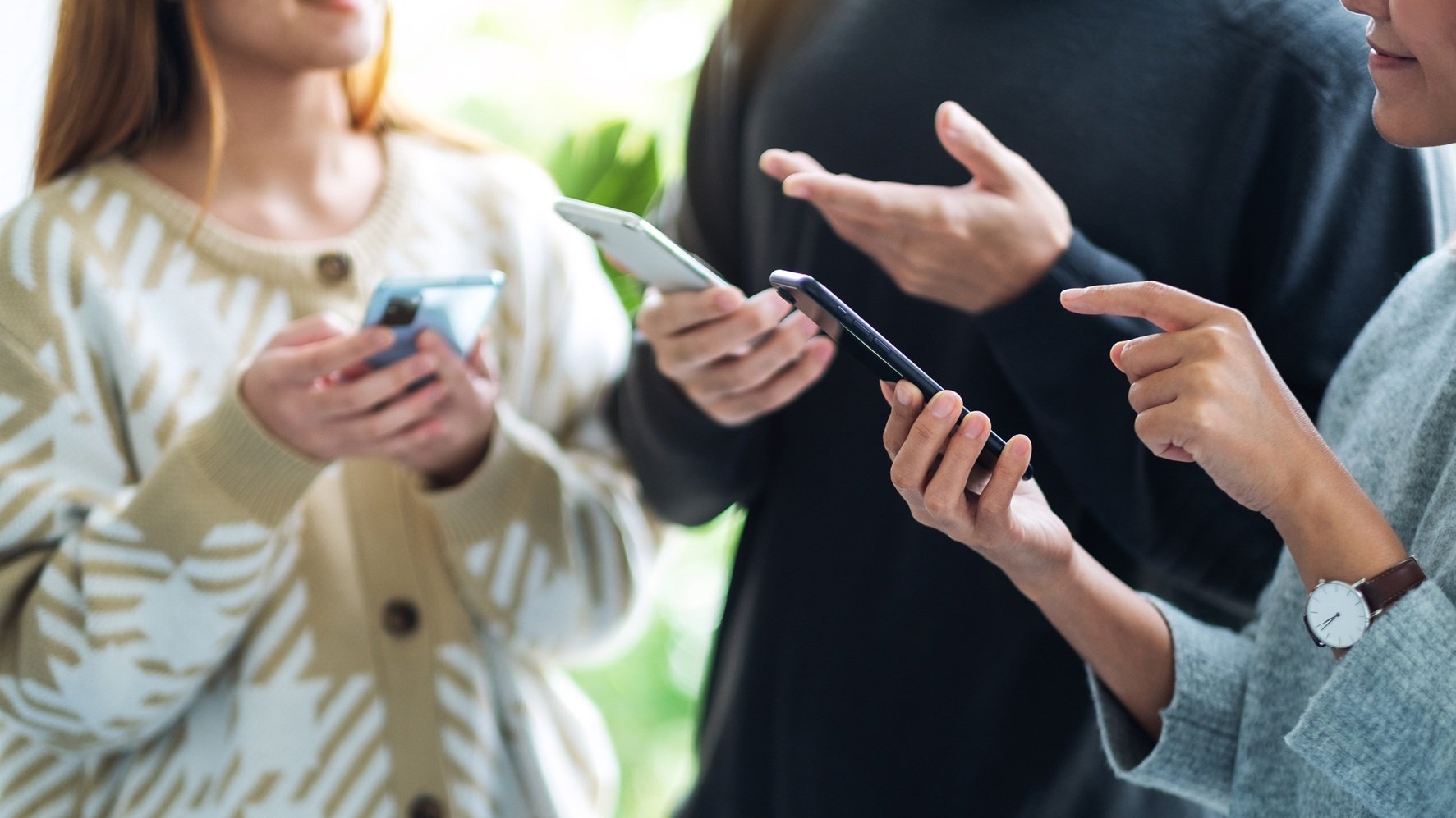 colleagues-discussing-data-on-mobile-devices-indoo-2026-03-26-22-50-09-utc
