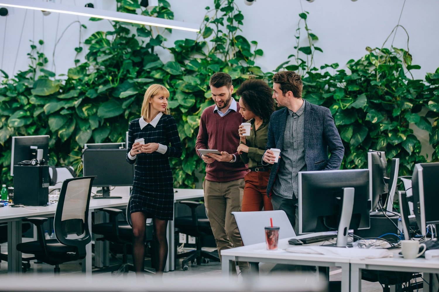 coworkers-collaborating-in-modern-office-with-gree-2026-01-05-05-22-07-utc