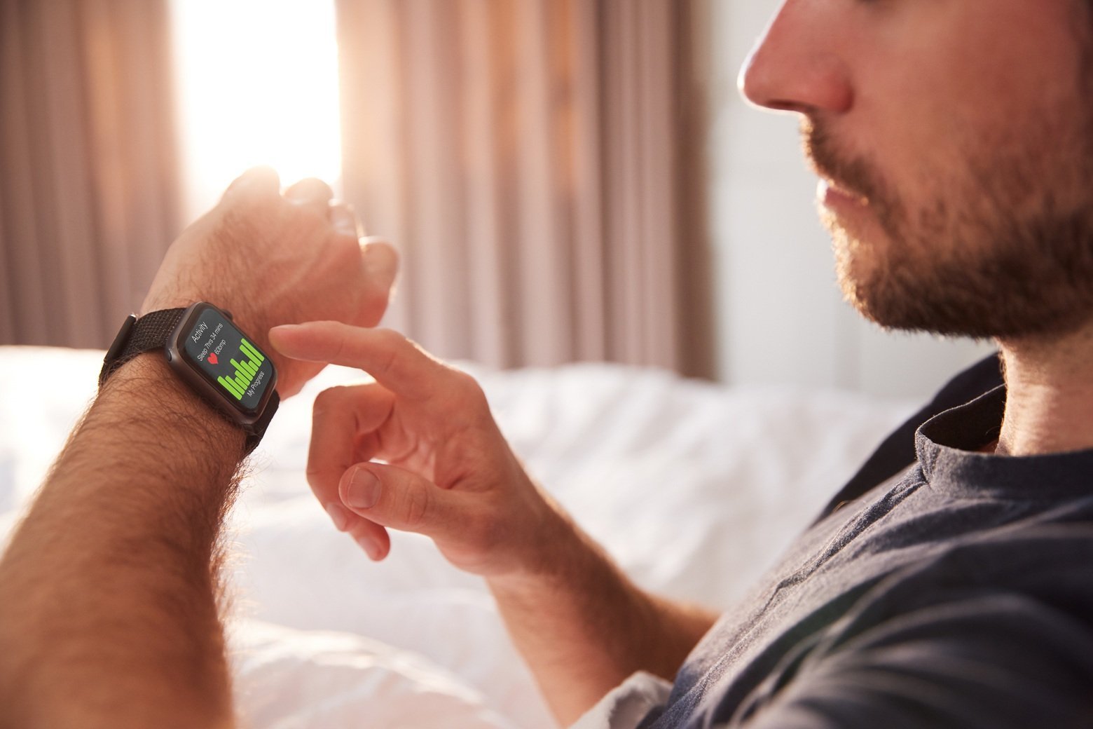 man-checks-smartwatch-health-data-in-morning-sunli-2026-03-10-03-56-39-utc