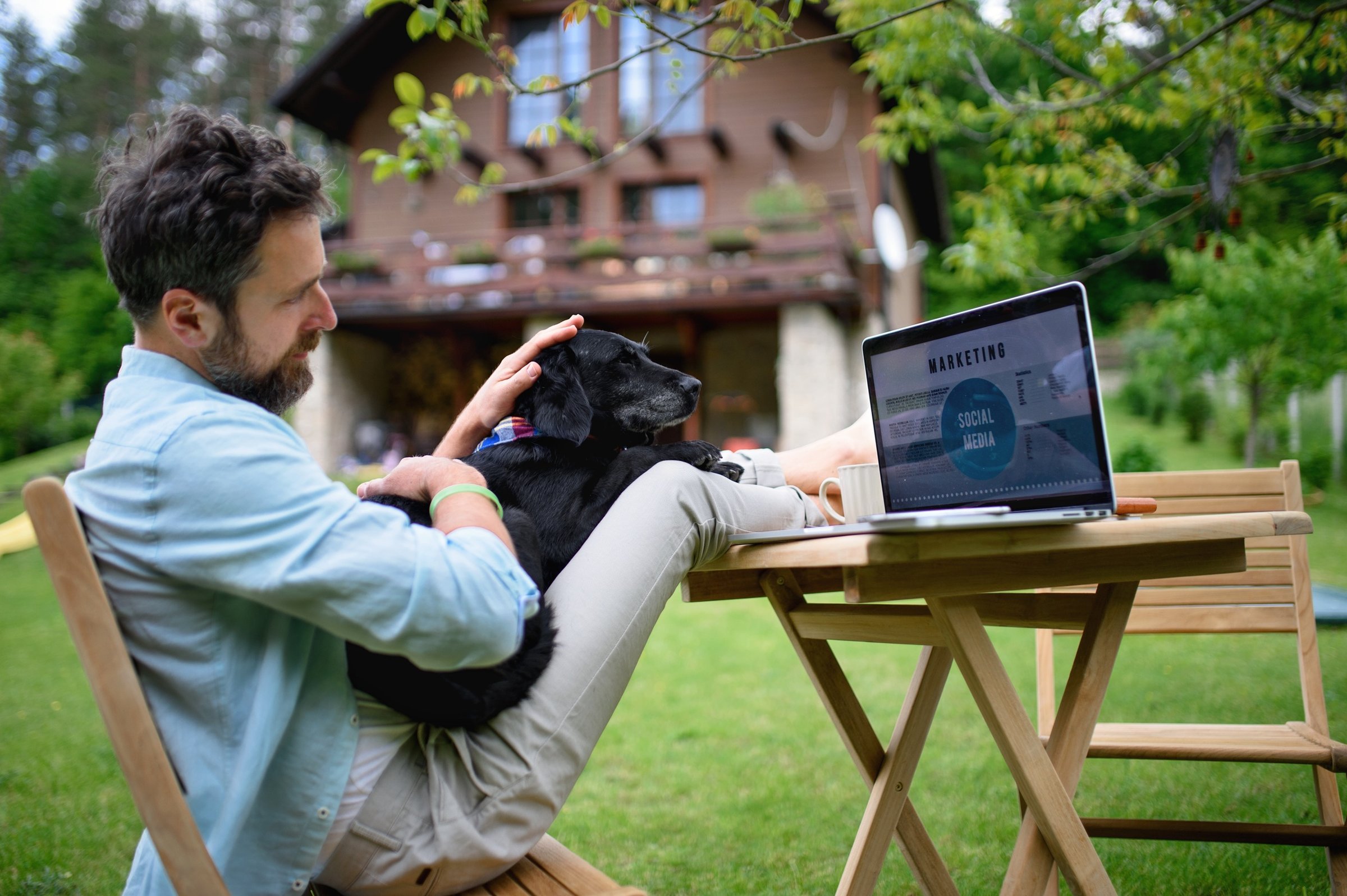 mature-man-with-laptop-and-dog-working-outdoors-in-2026-01-05-06-16-45-utc