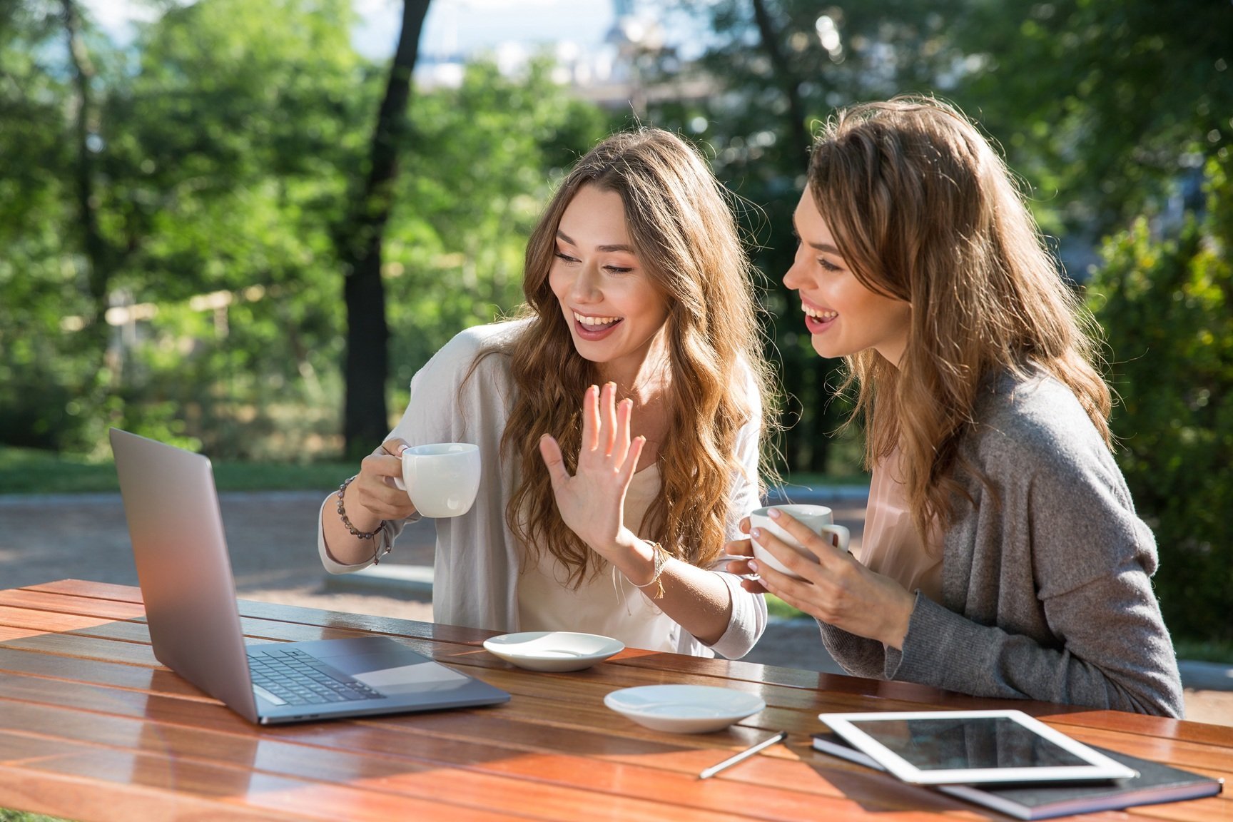 photo-of-smiling-young-two-women-sitting-outdoors-2026-01-09-14-55-50-utc