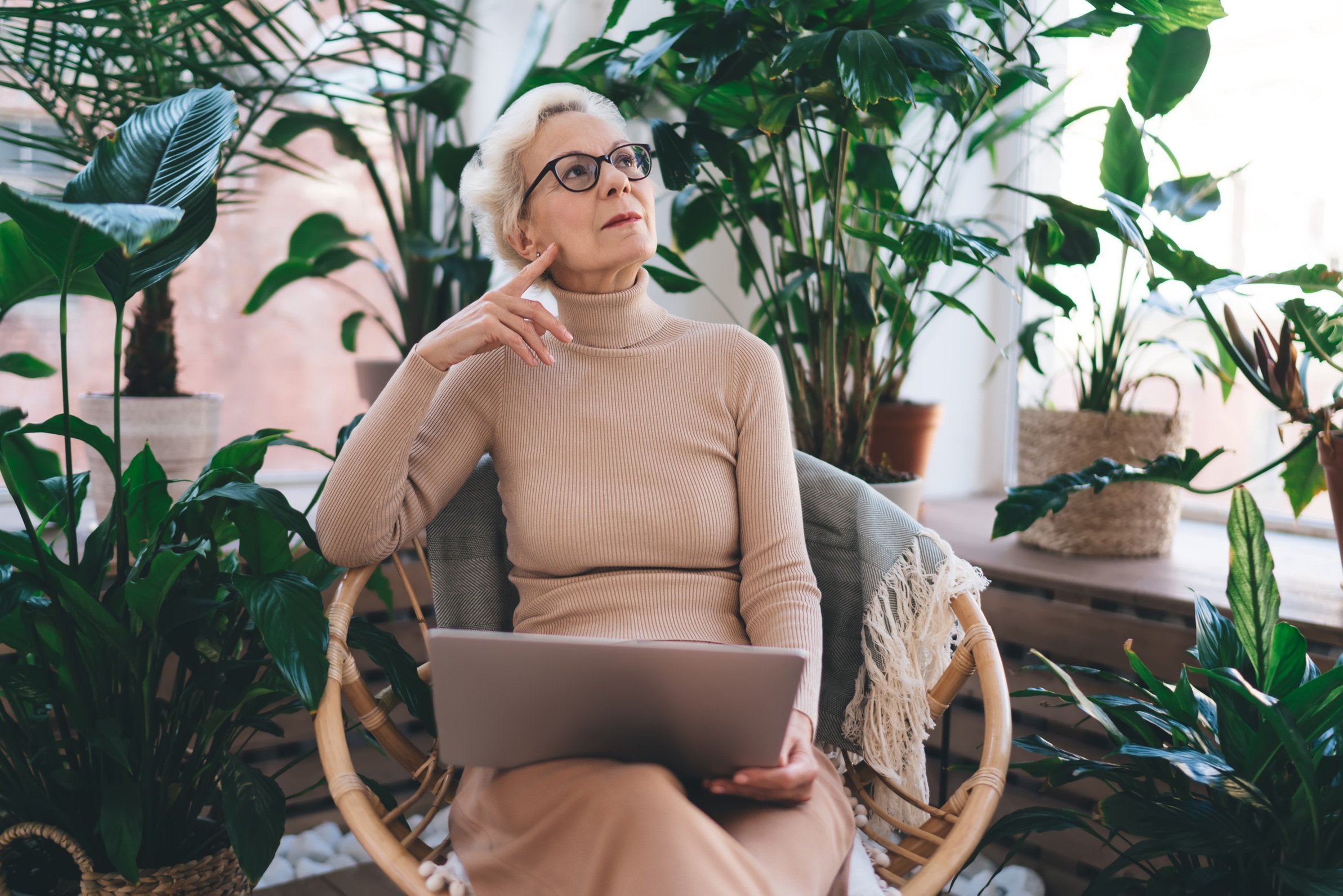 senior-woman-with-laptop-surrounded-by-houseplants-2026-03-24-22-48-50-utc