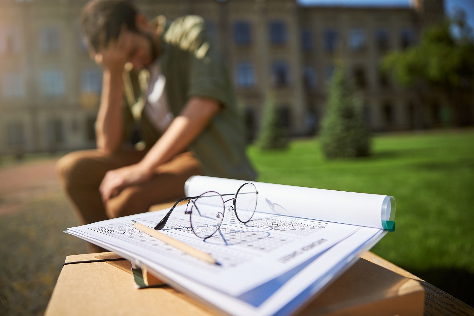 student-exam-stress-sitting-outside-on-campus-2026-03-24-05-08-12-utc
