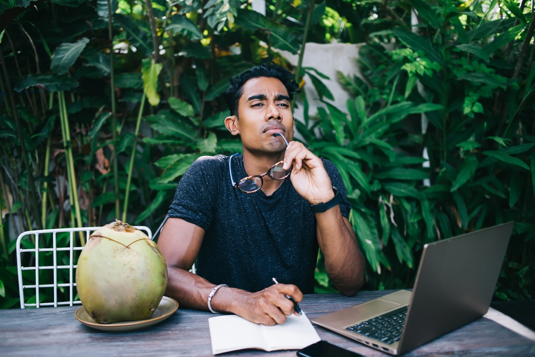 thoughtful-man-writing-in-notebook-on-terrace-2026-03-24-15-43-24-utc