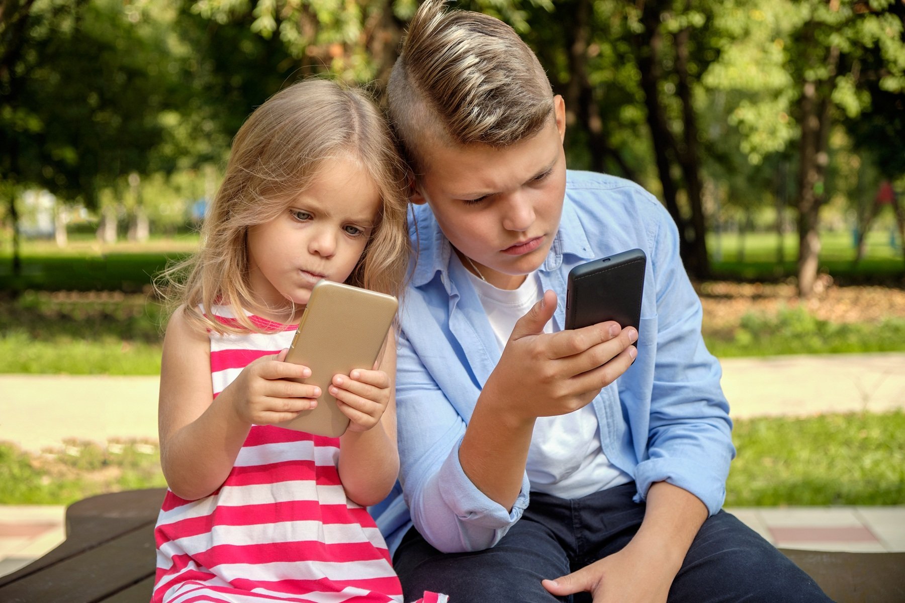two-happy-teenage-friends-using-on-mobile-phone-wh-2026-03-17-07-10-36-utc