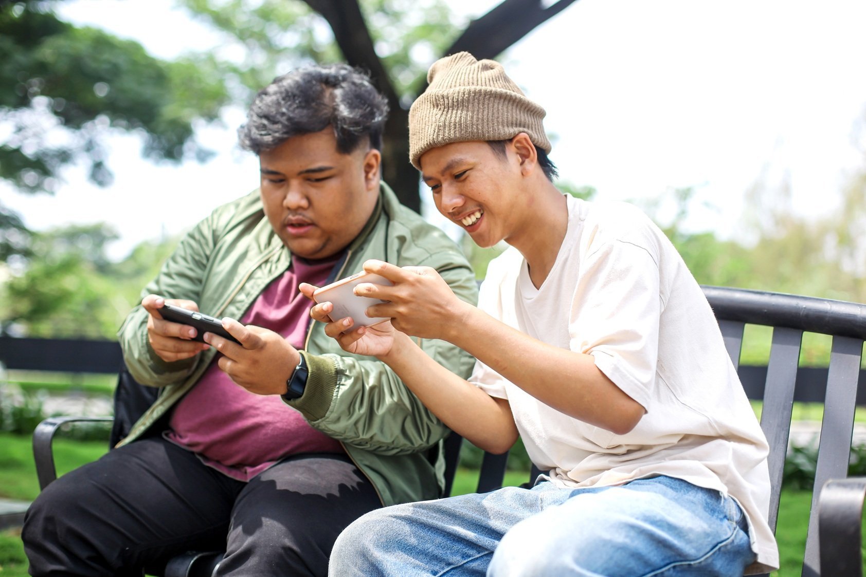 two-young-adults-enjoying-mobile-games-outdoors-2026-01-09-00-11-51-utc