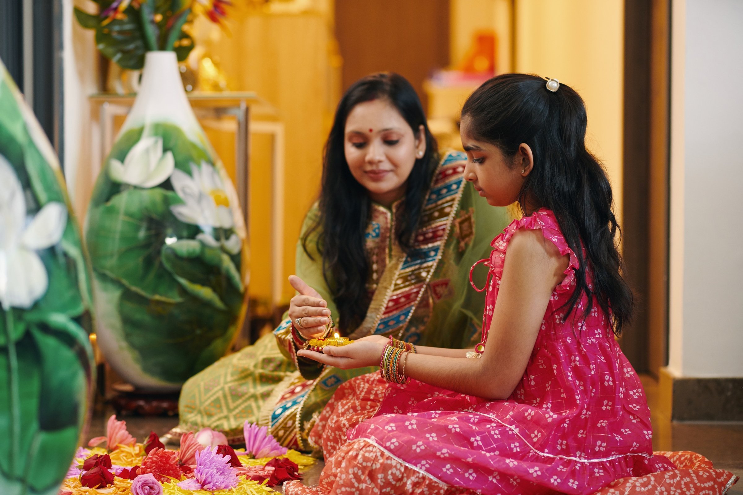 woman-and-girl-holding-oil-lamp-indoors-2026-03-18-14-59-36-utc