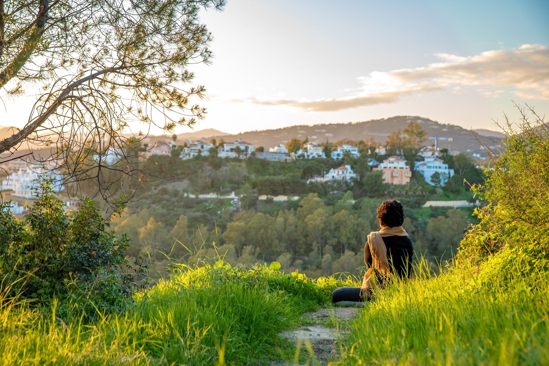 woman-relaxing-and-meditating-at-sunset-on-green-h-2026-03-17-08-41-51-utc