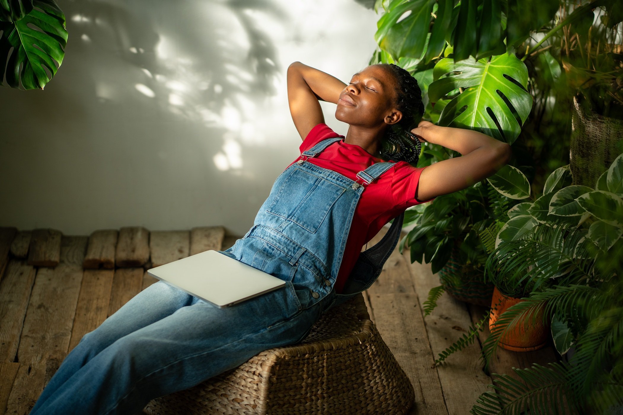 woman-relaxing-in-plants-indoors-with-laptop-2026-03-20-06-15-00-utc