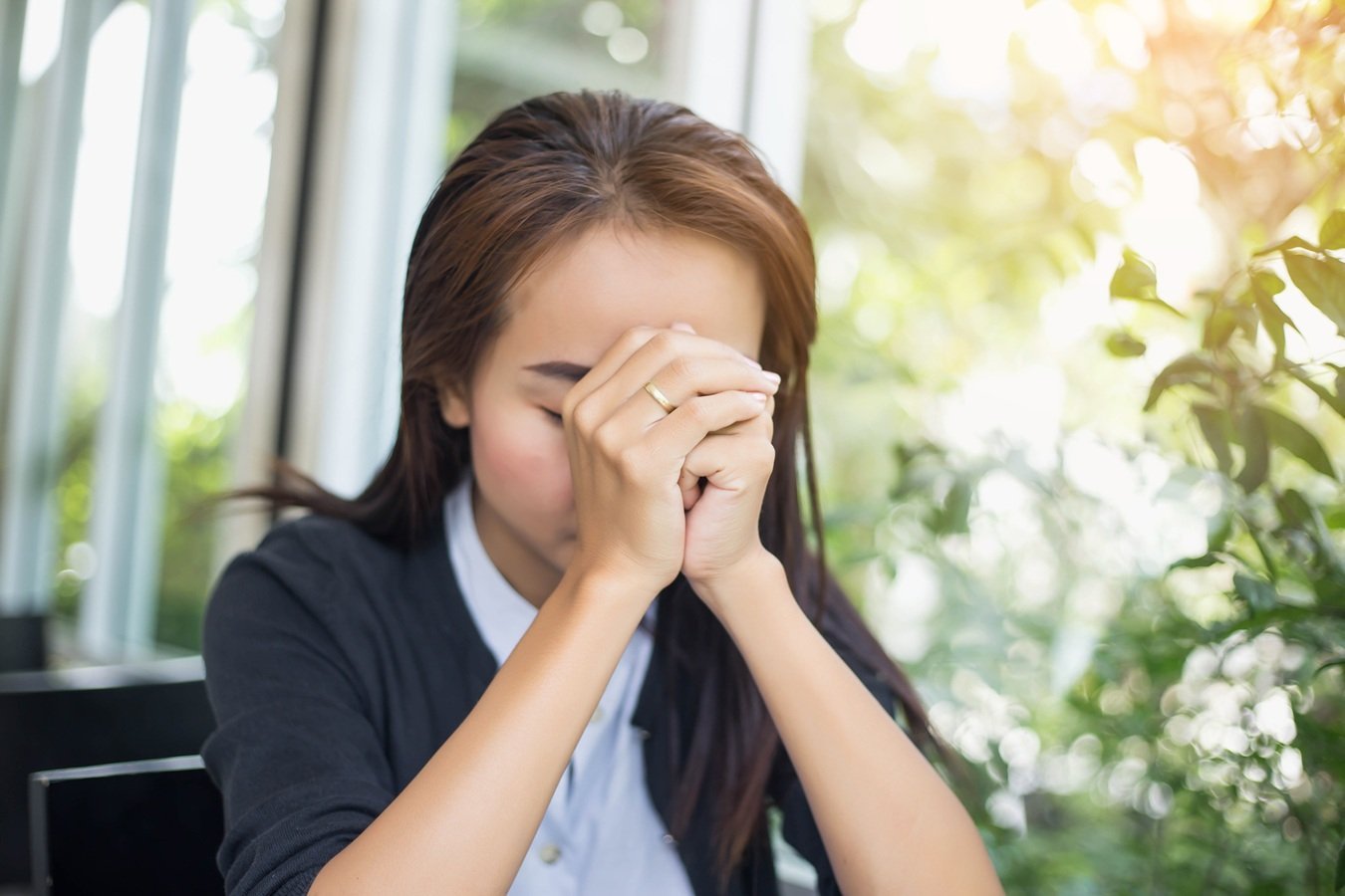 woman-with-eyes-closed-sits-indoors-2026-03-26-07-19-48-utc