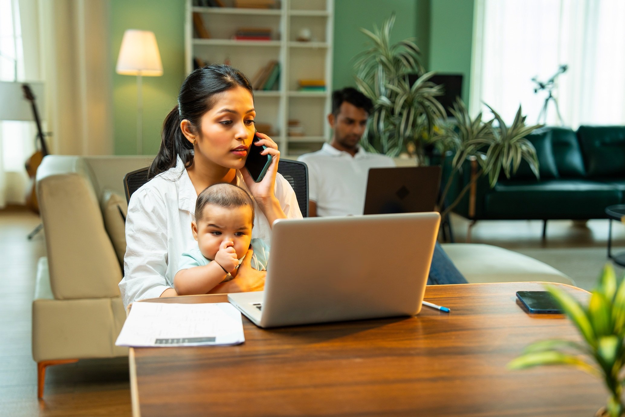 woman-working-from-home-with-infant-in-lap-2026-01-09-11-45-00-utc