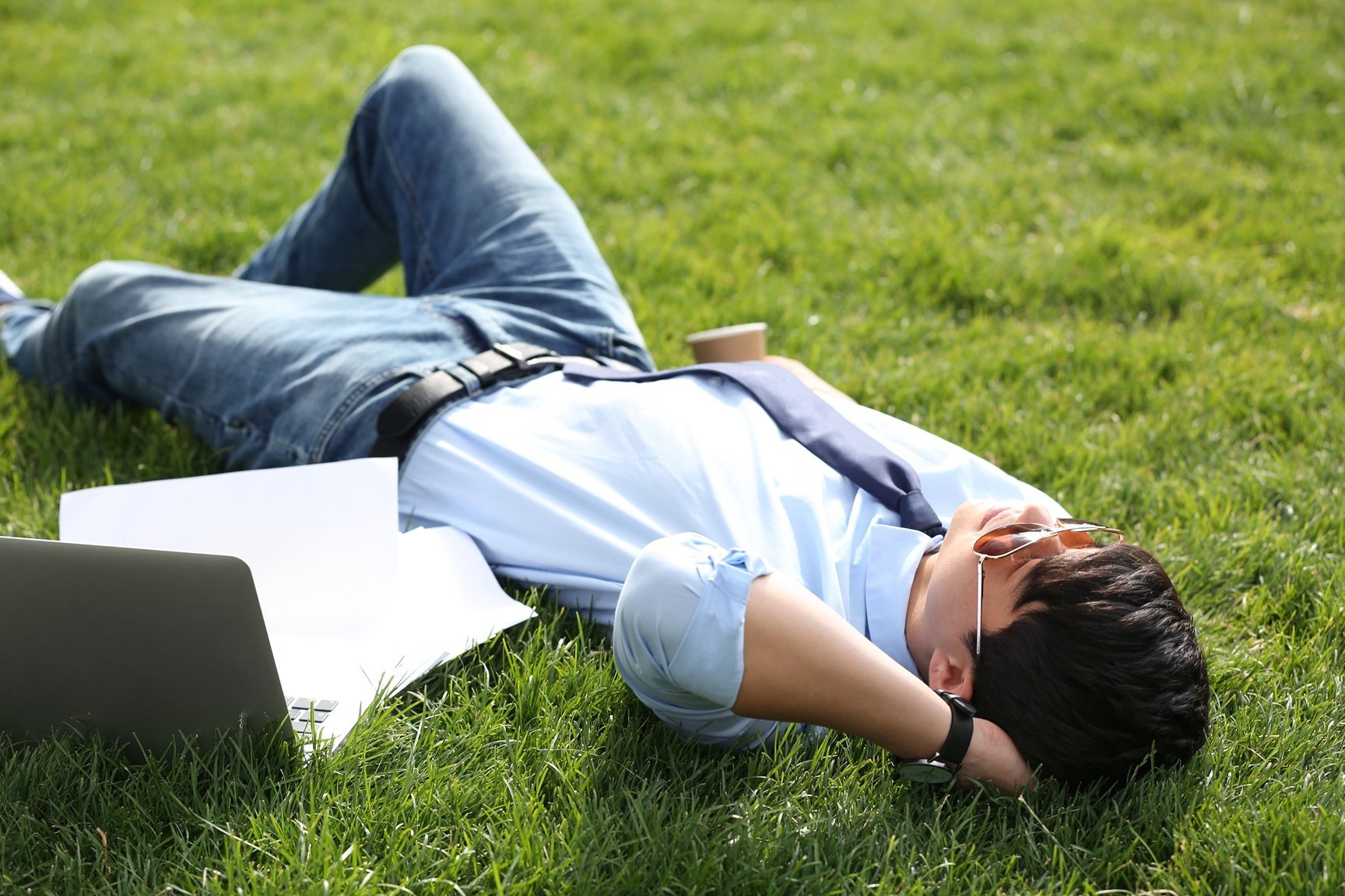 young-man-lying-on-green-lawn-in-park-joy-in-mome-2026-03-27-02-24-01-utc